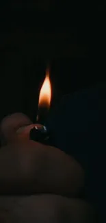 Hand holding a lighter, creating a dark and moody atmosphere.