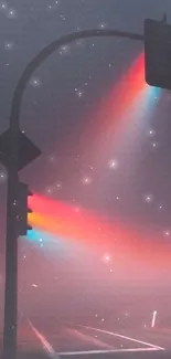 Traffic lights casting colorful beams in misty night.