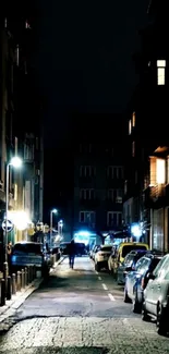 Dark urban street with glowing city lights at night.