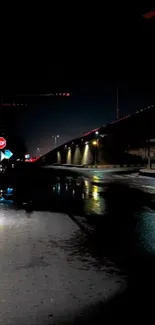 Moody night scene with wet street and reflections.