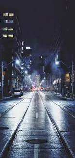 Moody city street at night with reflections and urban lights.