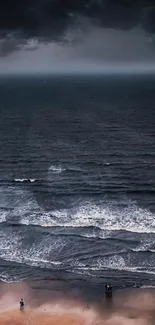 Moody beach with stormy dark clouds and distant ocean waves.