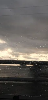 Moody rainy window view with cloudy sky and raindrops.