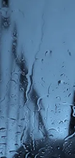 Moody blue rain-soaked window wallpaper with water droplets.