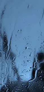 Moody dark blue rainy window wallpaper with water droplets.