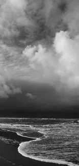 Black and white seascape with dramatic clouds and ocean waves.