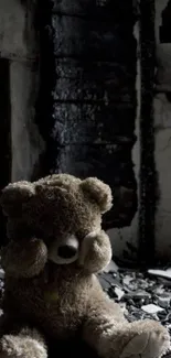 Moody teddy bear sitting in dark shadows.