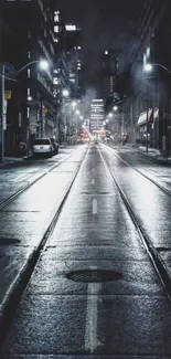 Moody urban street at night with city lights and misty atmosphere.