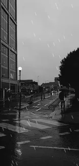 Black and white urban street at night with rain falling.