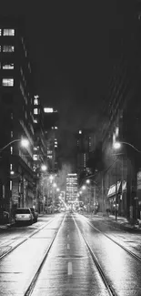 Black and white urban street at night, moody city scene.