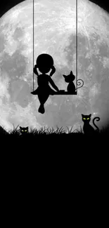 Girl and cats silhouetted against a full moon.