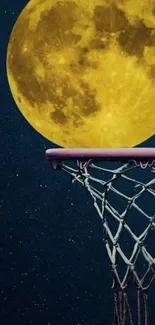 Full moon above basketball hoop against dark blue sky.