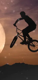 BMX cyclist jumping in front of the full moon at night.