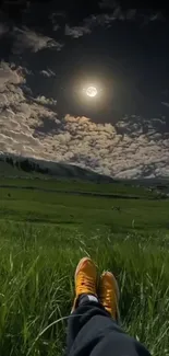 Feet resting in a moonlit grassy field.