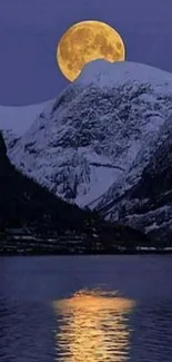 Moon rises over snowy mountains reflecting in a serene lake.