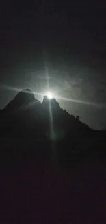 Wallpaper of a moonlit mountain silhouette at night.