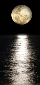 Full moon reflecting on a calm ocean at night wallpaper.