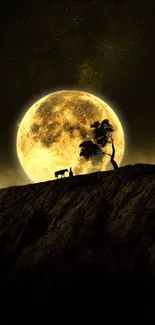 Silhouetted tree and cow against a large full moon.