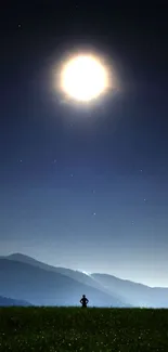 Silhouette under a luminous full moon in a serene night landscape.