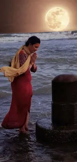 Woman meditating by moonlit ocean waves.