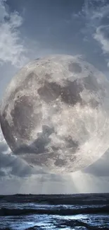 Moonlit ocean under a cloudy night sky.