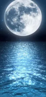 Full moon reflecting over calm blue ocean waves at night.