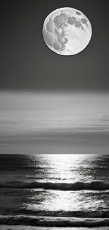 Moonlit ocean with reflections in a black and white serene setting.