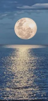 Full moon reflecting on a calm ocean at night, creating a serene atmosphere.