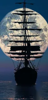 Silhouette of a ship against a full moon on the ocean at night.