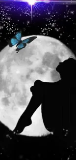 Silhouette against a full moon with a blue butterfly.