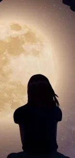 Silhouetted figure gazes at a glowing full moon against a starry night sky.