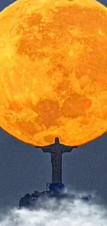 Silhouette of a statue beneath a large golden moon.