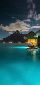 Moonlit tropical bungalow over turquoise water at night.