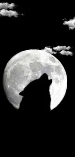 Wolf silhouette against a full moon with clouds.