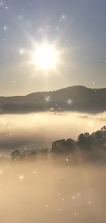 Sunrise over misty mountains with sunbeams shining through fog.