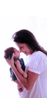 A joyful mother holding her smiling baby against a bright white background.