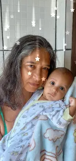 Mother holding baby in soft blanket, smiling.