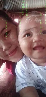 A mother and baby smiling joyfully in an intimate indoor setting.