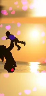 Silhouette of mother lifting child, sunset background with pink hearts.