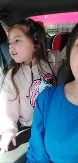 Mother and daughter selfie in a car with bright outfits.