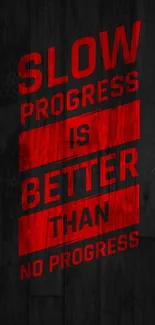 Motivational wallpaper with red text on black wood background.