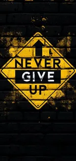 Yellow 'Never Give Up' sign on black brick wall.