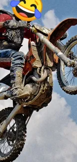 Motocross rider jumping with blue sky background.