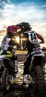 Motocross couple riding into the sunset with dramatic skies.