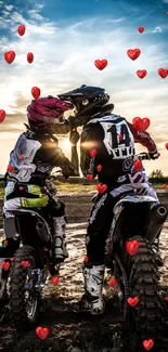 Two motocross riders under a scenic sunset.