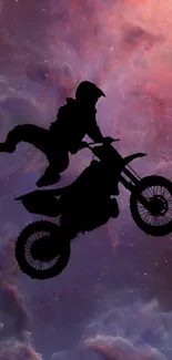 Motocross biker stunt against a galaxy backdrop.