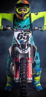 Motocross racer in neon gear riding a bike with dark smokey background.