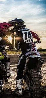 Motocross riders enjoy a sunset ride on dirt bikes.