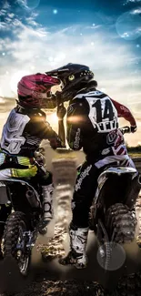 Motocross riders at sunset on dirt track, framed by dramatic sky.