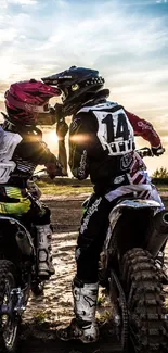 Two motocross riders racing at sunset in a scenic outdoor setting.